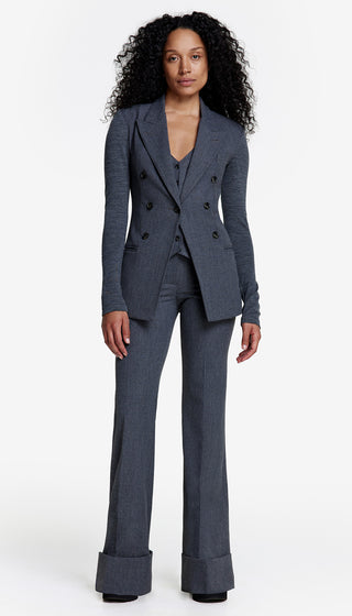 A woman modeling a professional outfit consisting of a blazer, a top, and the wide leg cuffed trouser in charcoal color.