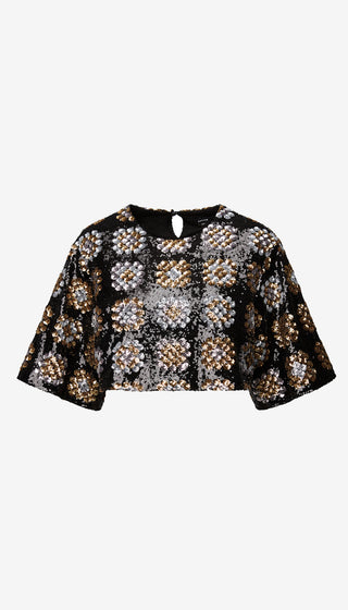 Black and gold patterned blouse on a white background