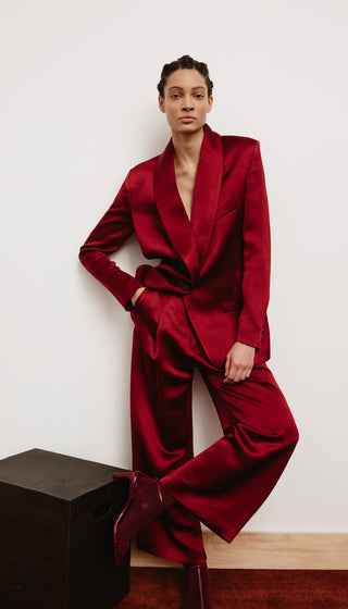 Person wearing a red suit against a white background