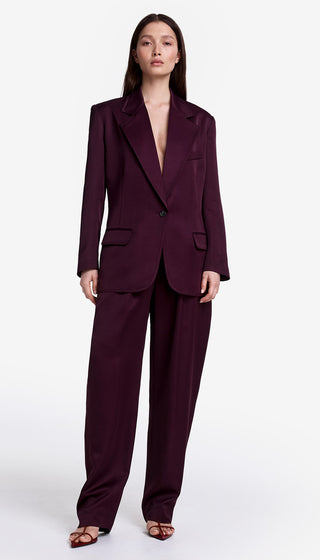 Woman wearing a burgundy suit on a white background