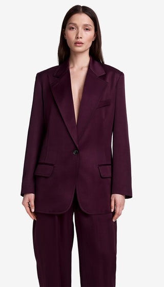 Woman wearing a burgundy suit on a white background