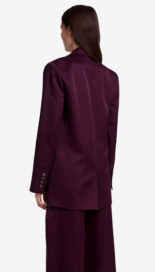 Person wearing a burgundy suit on a white background