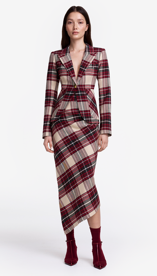 Woman wearing a plaid dress with a white background