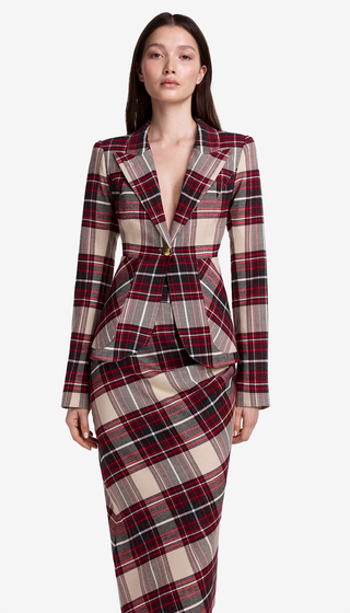 Woman wearing a plaid dress with a white background