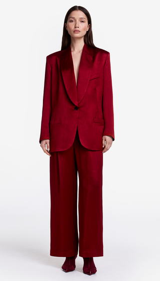 Woman wearing a red suit on a white background