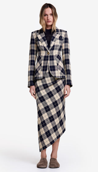 Woman wearing a plaid suit with a white background