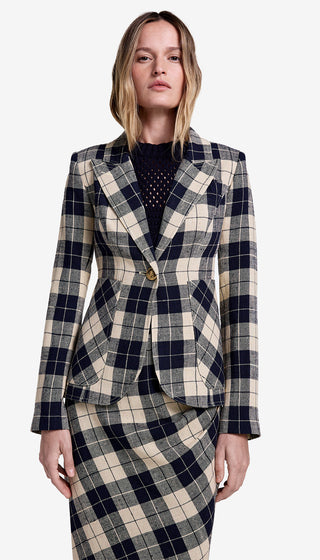 Woman wearing a plaid suit on a white background
