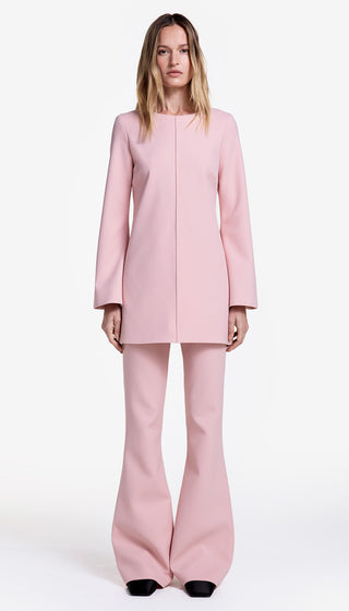 Pink suit worn by a model on a white background