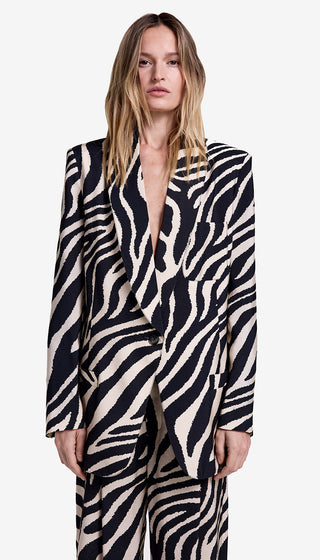 Woman wearing a zebra print suit on a white background