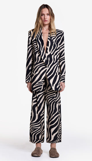 Woman wearing a zebra print suit on a white background