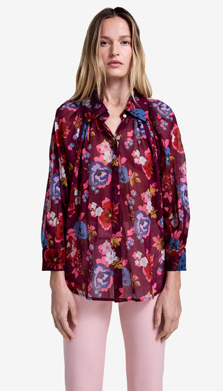 Woman wearing a floral blouse with a white background