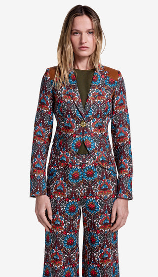 Woman wearing a colorful patterned suit on a white background