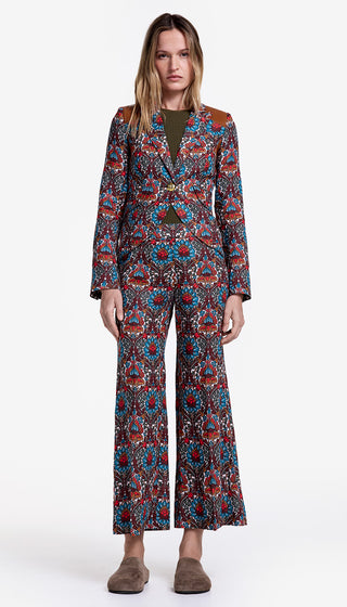 Woman wearing a patterned suit on a white background
