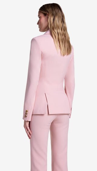 Woman wearing a pink suit on a white background