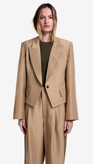 Woman wearing a beige suit on a white background
