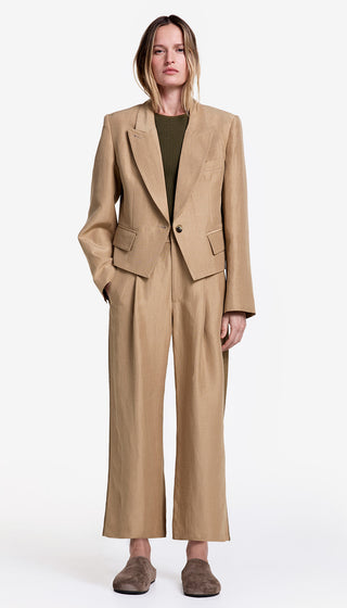 Woman wearing a beige suit on a white background