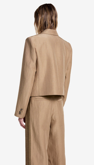 Person wearing a beige suit on a white background