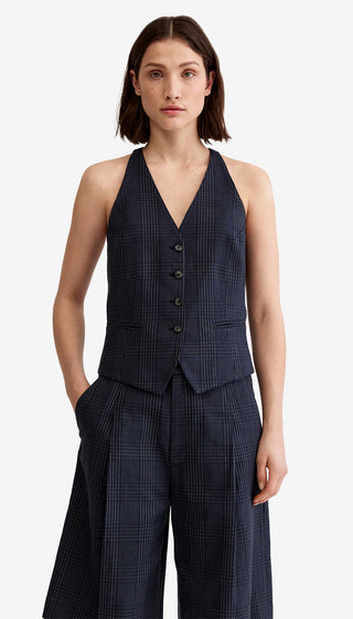 Woman wearing a navy checkered suit on a white background
