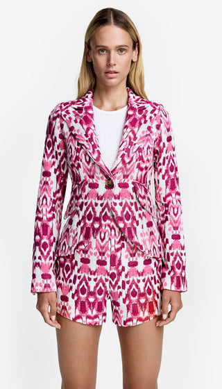 A model wearing a pink geometric patterned one button blazer with shorts.