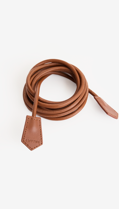 Brown leather belt with a buckle on a white background