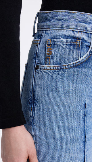 Close-up of blue jeans with a white background