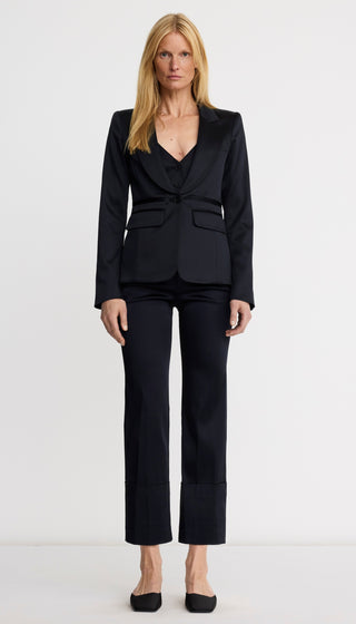Woman wearing a black suit on a white background