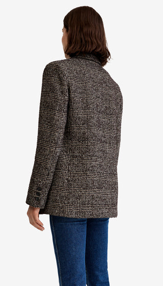 Person wearing a patterned coat on a white background
