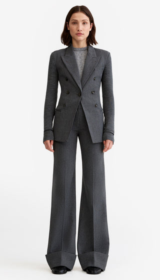 Woman wearing a gray suit on a white background