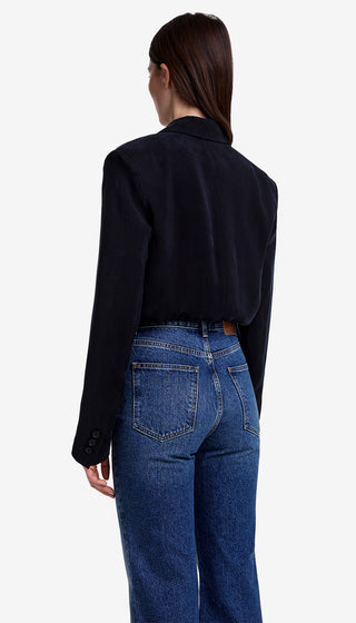 Person wearing a black shirt and blue jeans on a white background