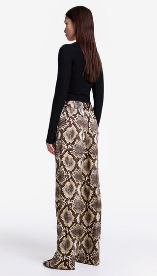 Woman wearing snake print pants on a white background