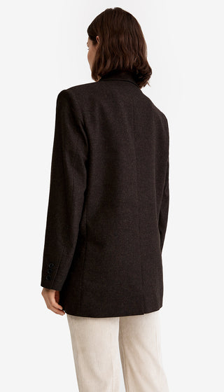 Person wearing a black coat on a white background