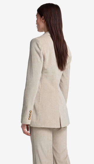 Woman wearing a beige suit with a white background