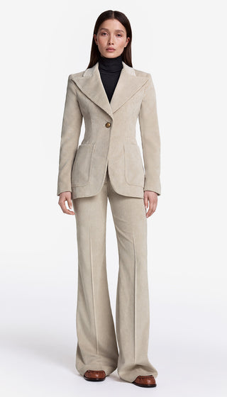 Woman wearing a beige suit on a white background