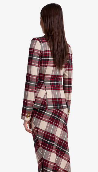 Woman wearing a plaid dress with a white background