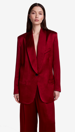 Red suit worn by a model on a white background