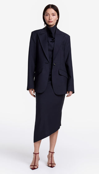 Woman wearing a navy blue suit on a white background