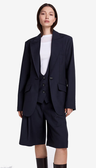 Person wearing a navy blue suit with a white shirt on a white background