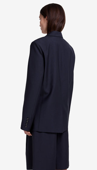 Person wearing a navy suit on a white background