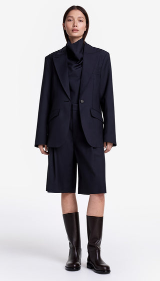 Person wearing a navy suit with a white background