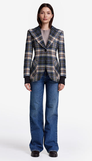 Person wearing a plaid blazer and blue jeans on a white background