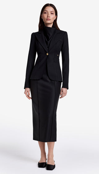 Woman wearing a black suit on a white background