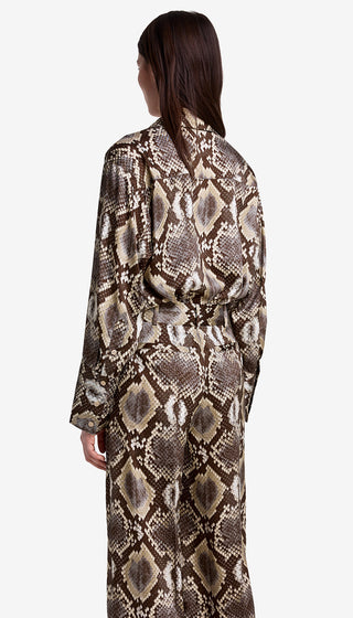 Person wearing a snake print dress on a white background