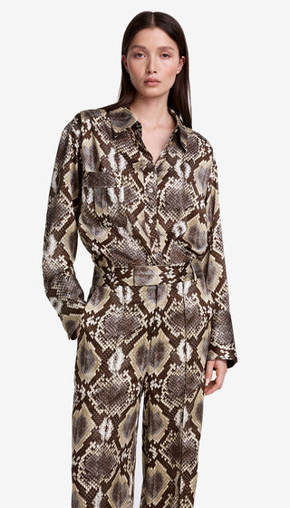 Woman wearing a snake print jumpsuit on a white background