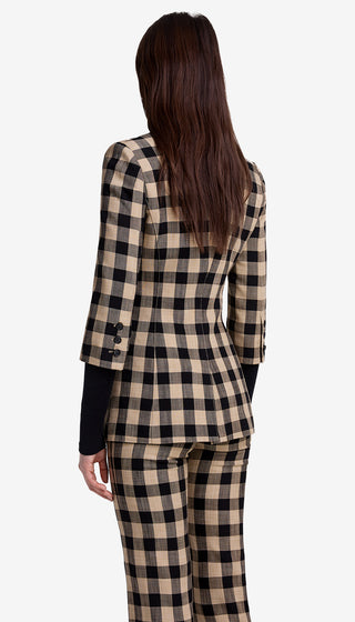 Woman wearing a checkered suit with a white background