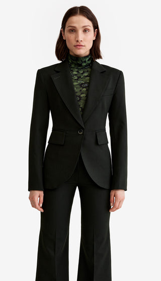 Woman wearing a black suit with a white background