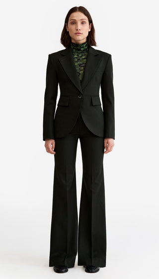 Person wearing a black suit with a white background