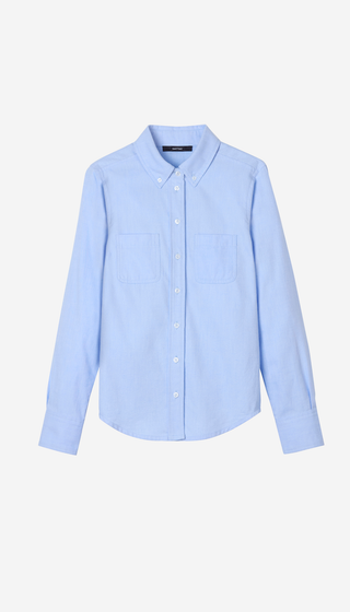 A light blue long-sleeve button-up shirt with two chest pockets, displayed flat against a clean off-white background.