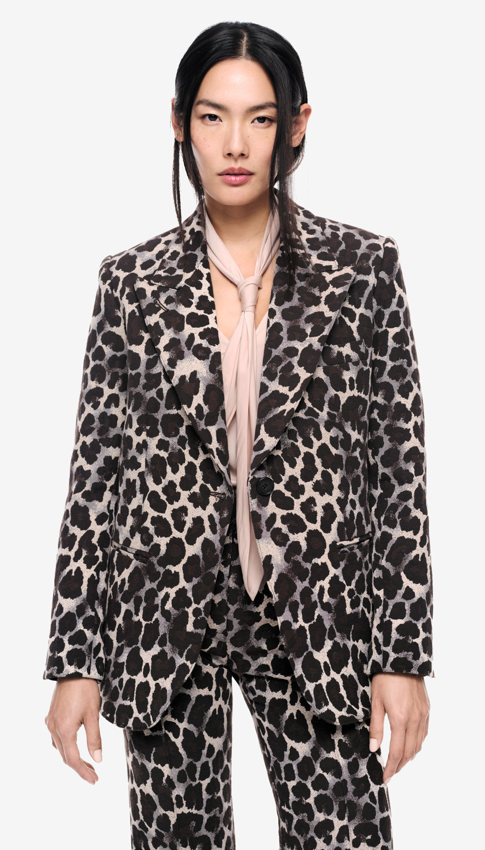 A woman in a leopard print blazer.