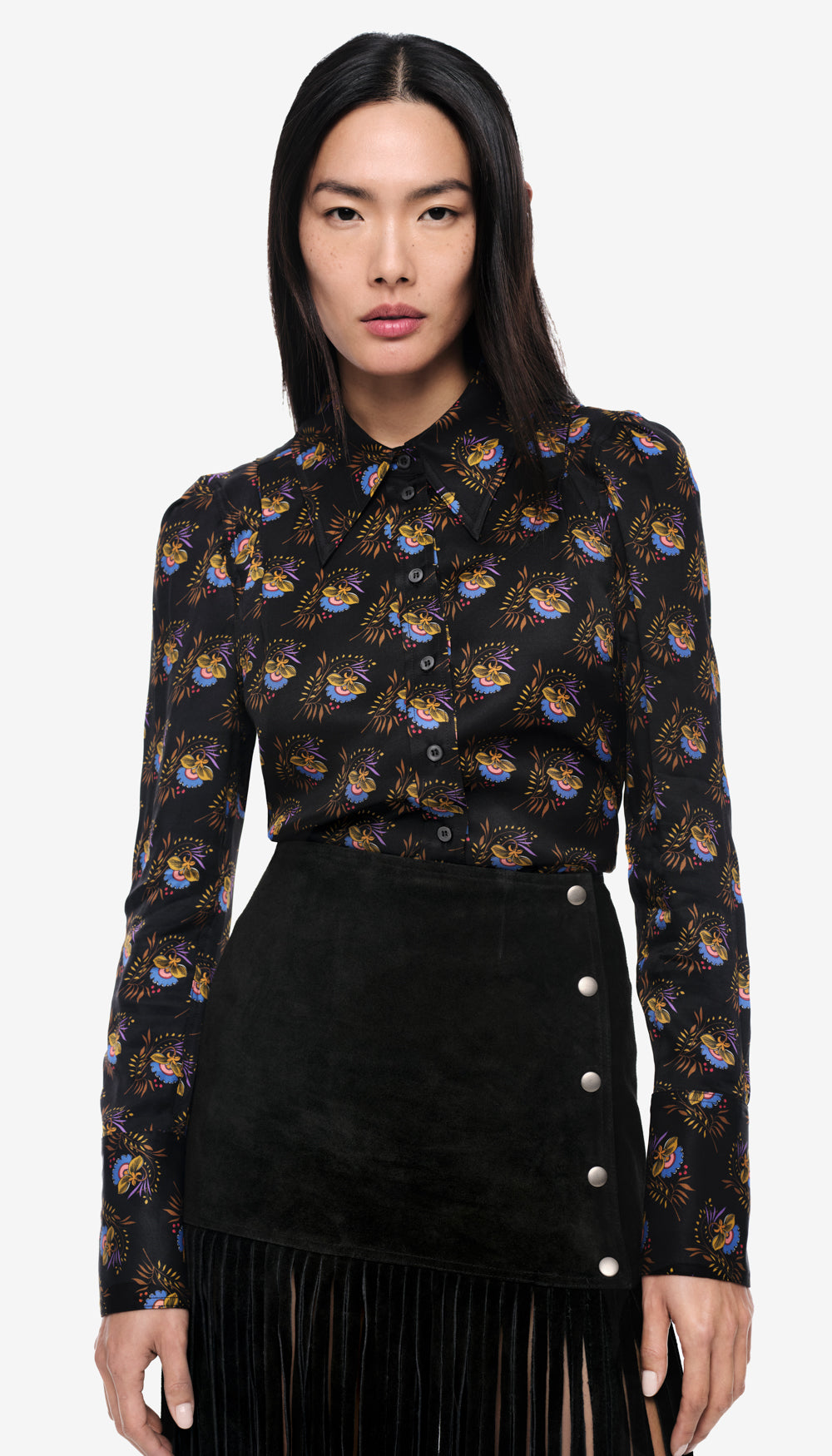 A woman in a black floral blouse.
