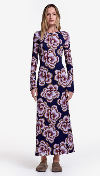 Woman wearing a long floral dress on a white background